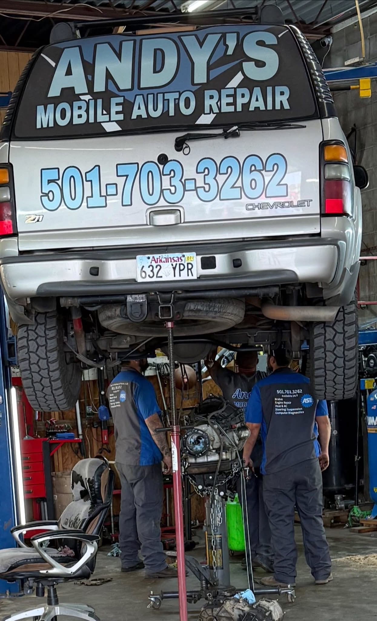 Technicians working beneath a vehicle